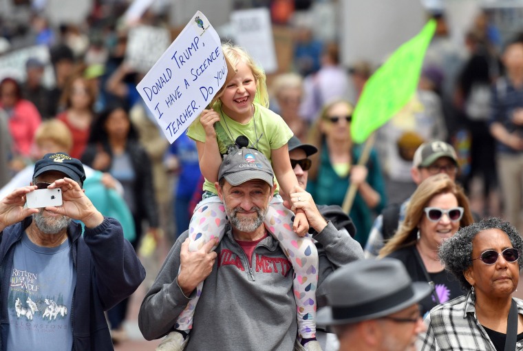 Image: A man and child join the march in San Francisco.
