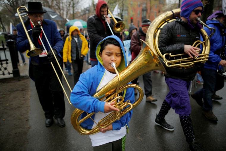 Image: A brass band walks with demonstrators marching down Commonwealth Avenue from Massachusetts Institute of Technology (MIT) to the March for Science rally on the Common in Boston.