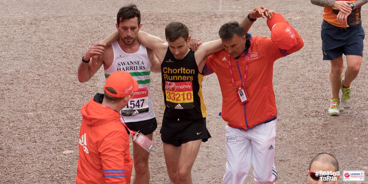 Image: London Marathon runner Matt Rees helps fellow participant David Wyeth to cross the finish line, April 23, 2017.