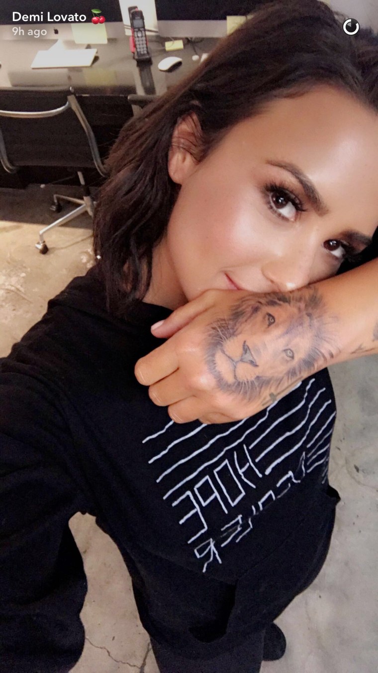 Demi Lovato shows off her new tattoo. 