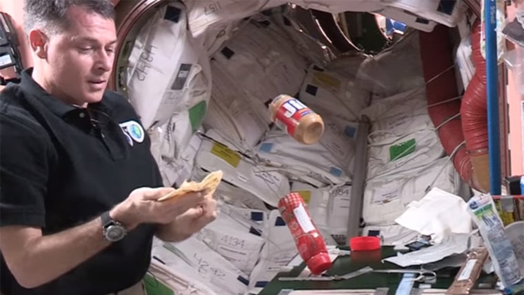NASA astronaut making a peanut butter and jelly sandwich in space
