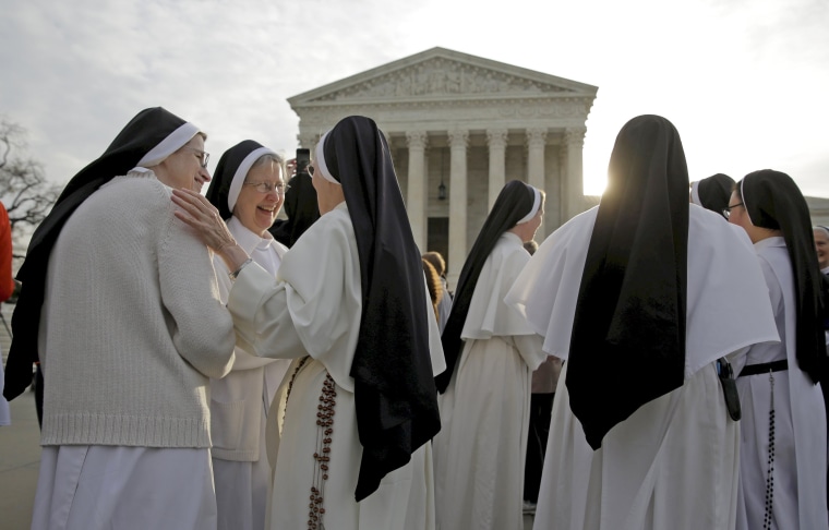Image: Nuns speak to each other before Zubik v. Burwell is heard by the U.S. Supreme Court in Washington