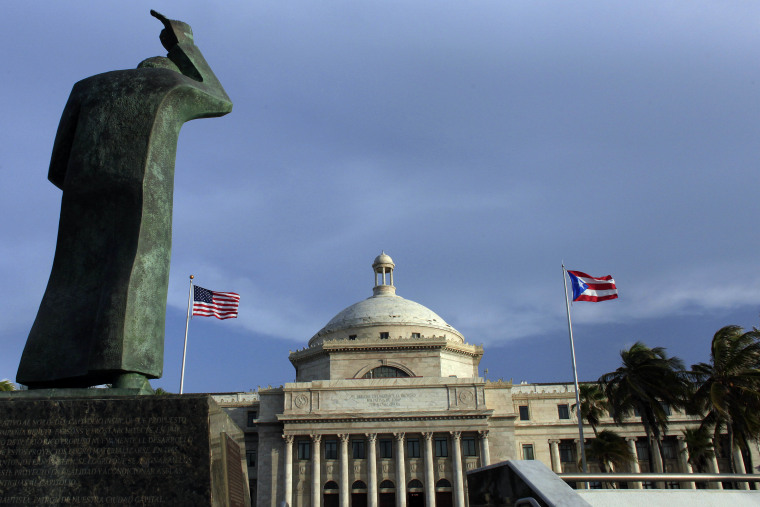 File photo Puerto Rico's Capitol flanked by U.S. and Puerto Rican flags, in San Juan.