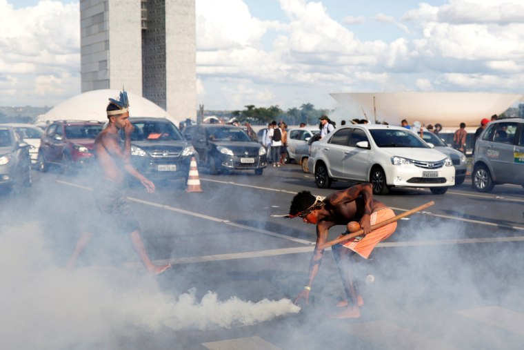 Image: Brazilian Indians take part in a demonstration against the violation of indigenous people's rights, in Brasilia