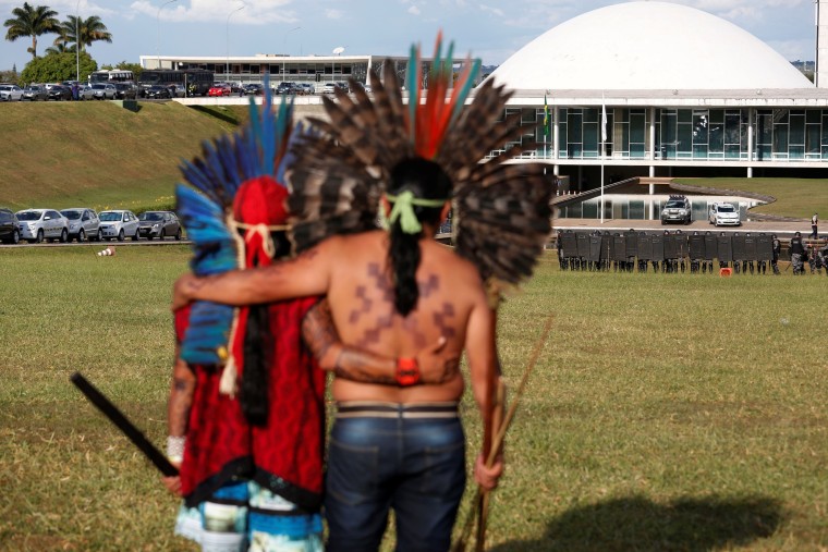 Image: Brazilian Indians take part in a demonstration against the violation of indigenous people's rights, in Brasilia
