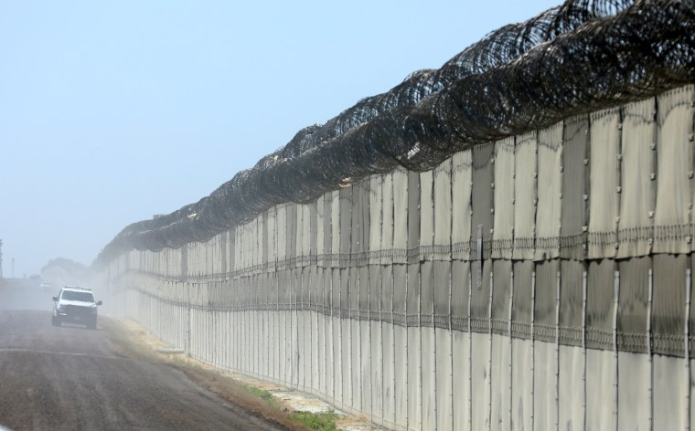 Image: A U.S. Customs and Border Patrol officer patrols along the border