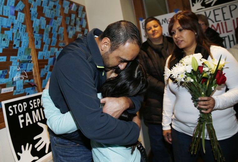 Image: Arturo Hernandez, left, hugs his 9-year-old daughter, Andrea, with his wife, Ana Sauzameda standing next to them