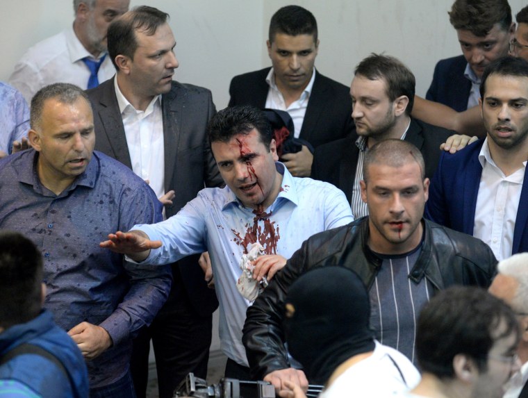 Image: Zoran Zaev, surrounded by security, leaves Parliament after protestors attacked him