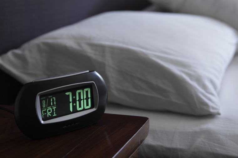 Alarm clock by bed
