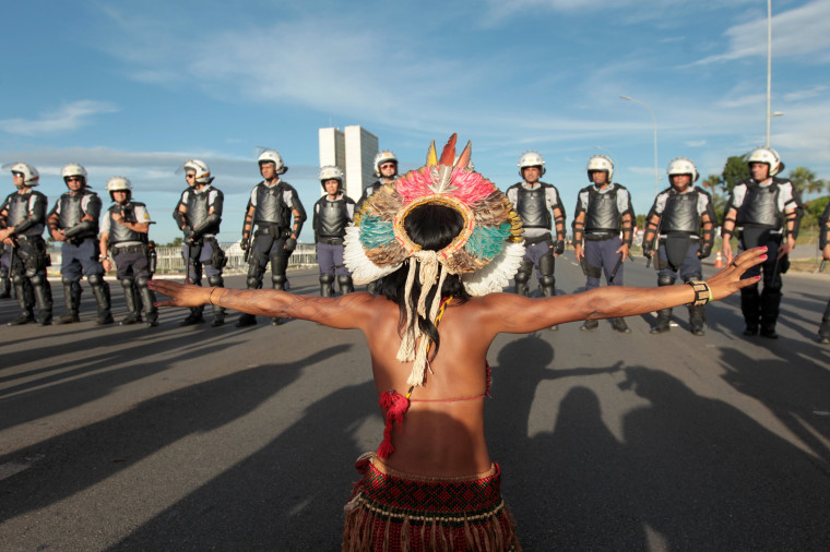 Image: An indigenous person gestures towards police in protest on April 27, 2017 in Brasilia, Brazil.