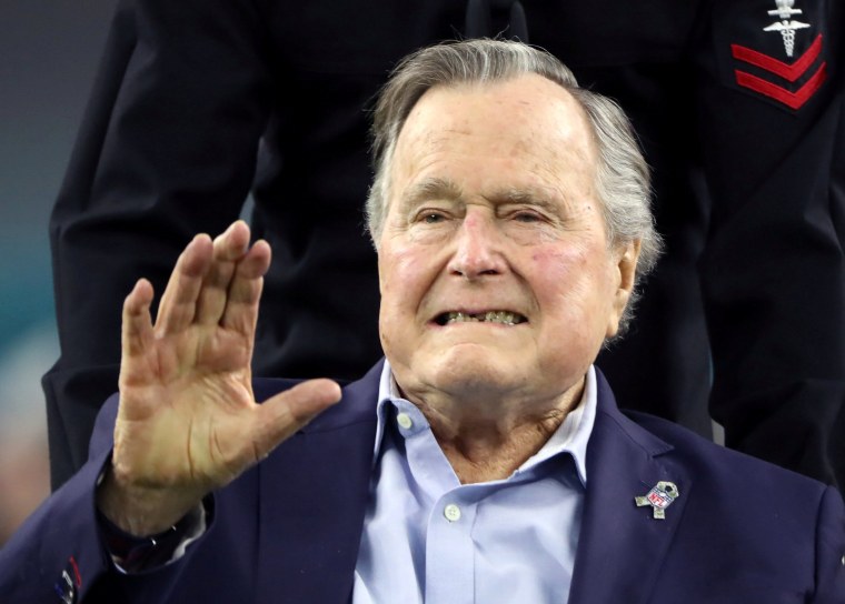 Image: Former U.S. President George H.W. Bush arrives on the field ahead of the start of Super Bowl LI