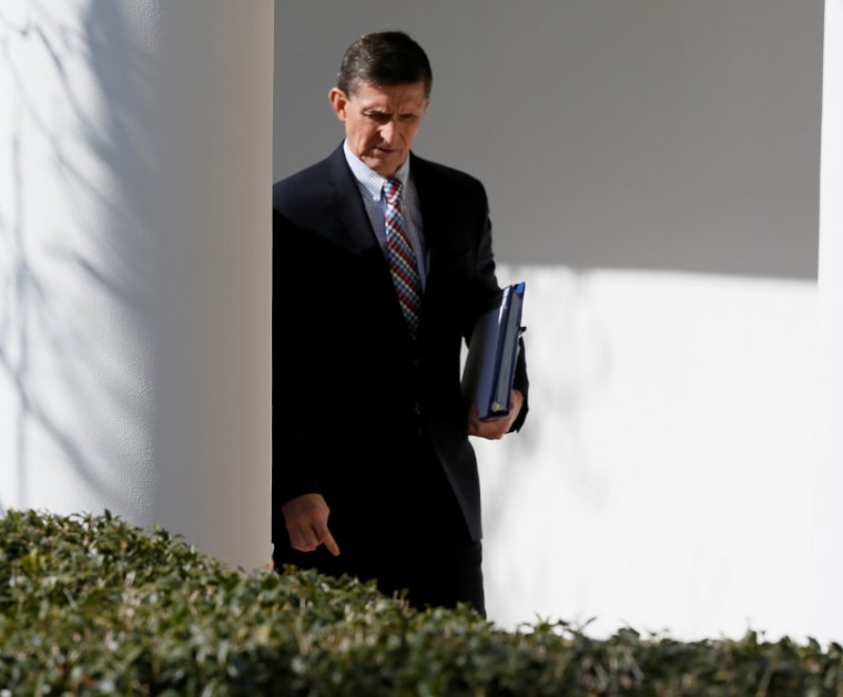 Image: Michael Flynn walks down the White House colonnade