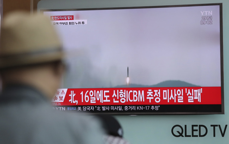 Image: A man watches a TV news program reporting about North Korea's missile firing with a file footage in Seoul.