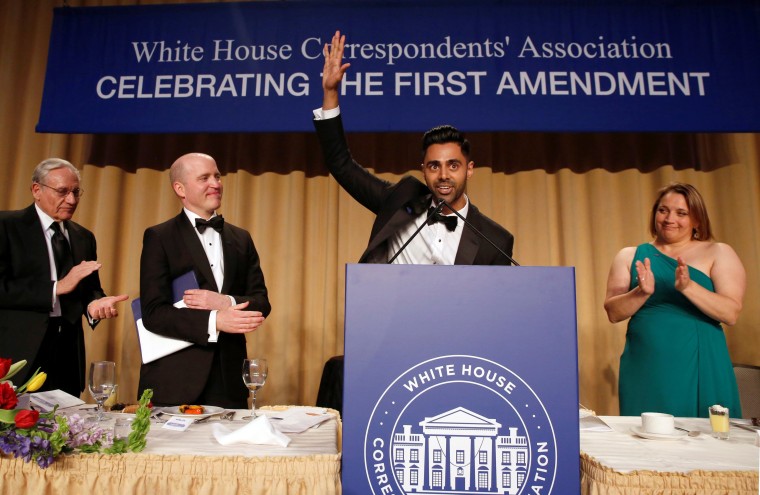 Image: Members of the head table applaud as Minhaj finishes his performance at the White House Correspondents' Association dinner in Washington