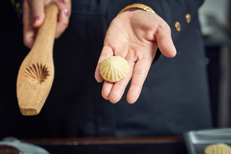 Ruwaida's cookies are hand-molded using a wooden mold she received from her own mother.