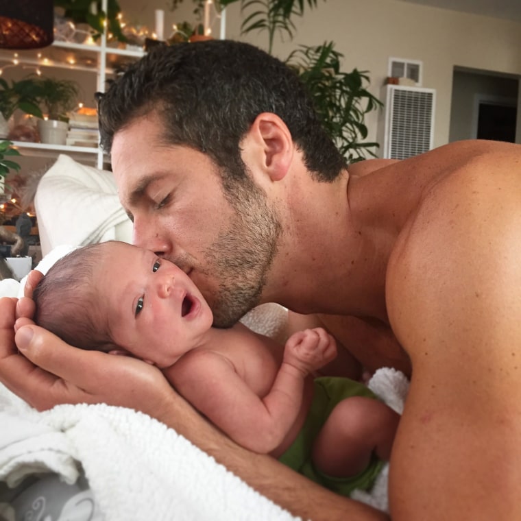 Daniel Eisenman kisses his baby girl.