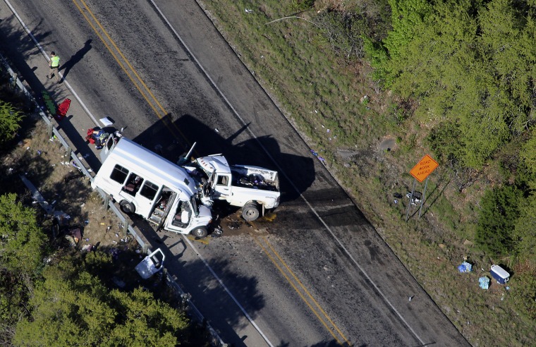 Image: Officials investigate the scene of a crash involving members of a church group