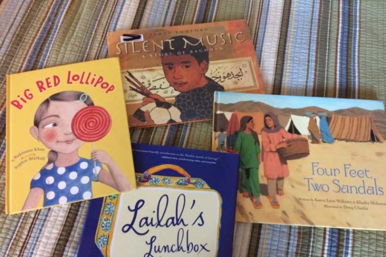 Books include "Big Red Lollipop" by Rukhsana Khan and Sophia Blackall, "Silent Music" by James Rumford, "Four Feet, Two Sandal" by Karen Lynn Williams and Khadra Mohammed, and "Lailah's Lunchbox" by Reem Faruqi.