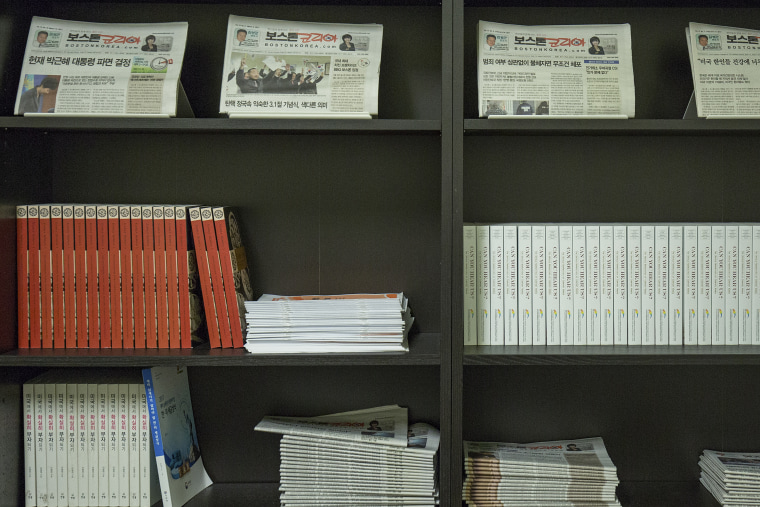 Previous issues of Boston Korea lines the walls of the newspaper office.