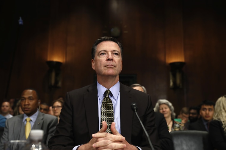 Image: FBI Director James Comey prepares to testify on Capitol Hill