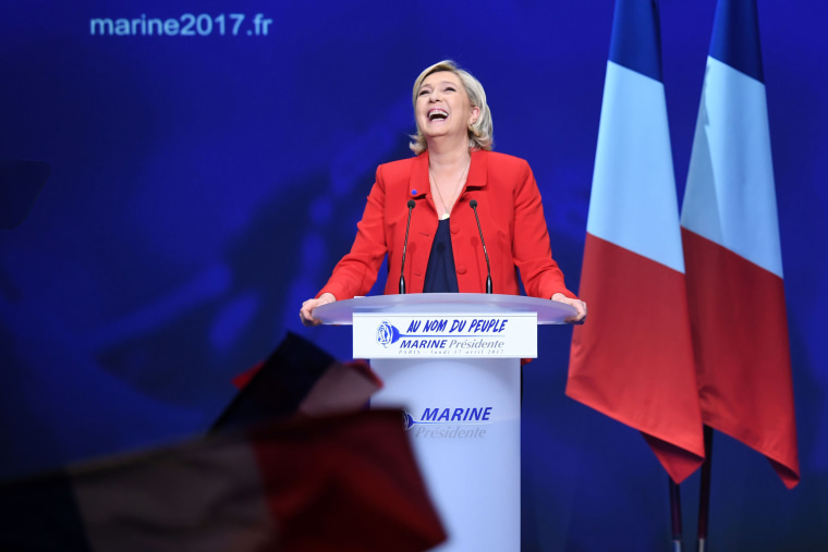 Image: Marine Le Pen reacts on stage during a campaign meeting in Paris