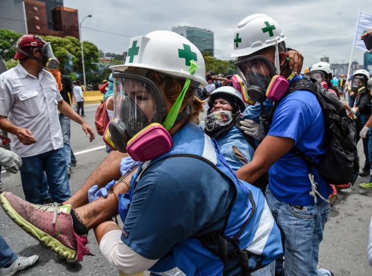 Image: An opposition demonstrator wounded during clashes with riot police in Venezuelan 