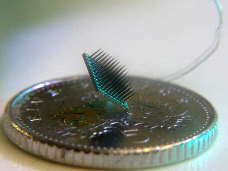 The brain chip sits on a British 5 pence coin.