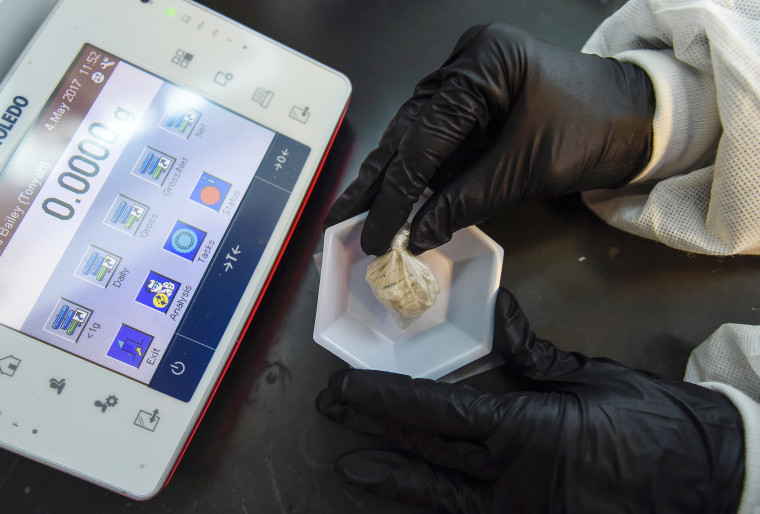 Image: A forensic chemist prepares a sample of the drug "gray death" to be weighed at the crime lab of the Georgia Bureau of Investigations