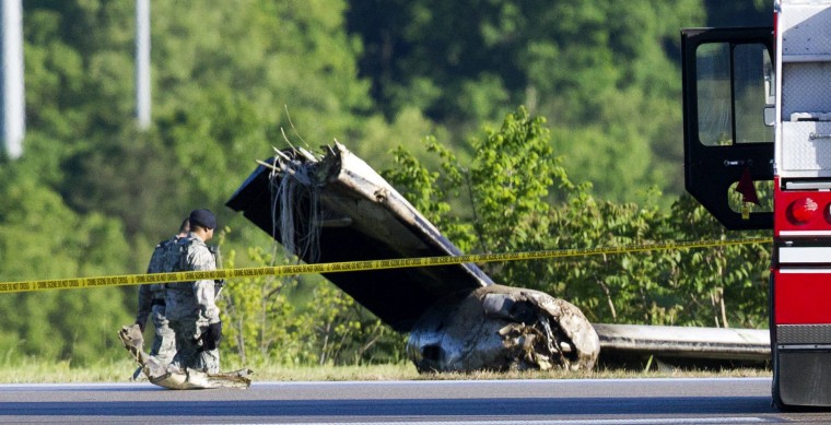 Image: Part of a cargo plane lays on the ground following a fatal crash at Yeager Airport in Charleston, W. Va.