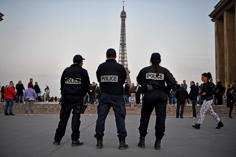Image: Police stand in front of the Eiffel Tower in Paris
