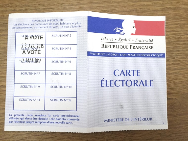 Image: A voter registration card pictured as voters prepare to vote for the second round of the French presidential election