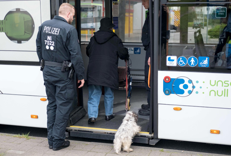 Image: A police officer helps an old woman of the district Vahrenwald in Hanover, central Germany, during the evacuation on May 7, 2017.