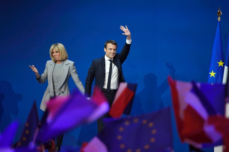 Image: French presidential election candidate for the En Marche ! movement Emmanuel Macron and his wife Brigitte Trogneux arriving on stage at the Parc des Expositions in Paris, after the first round of the Presidential election.