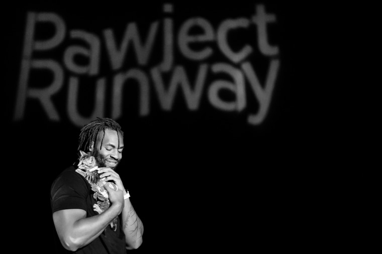 Matt Judon, outside linebacker for the Baltimore Ravens, helps with Pawject Runway