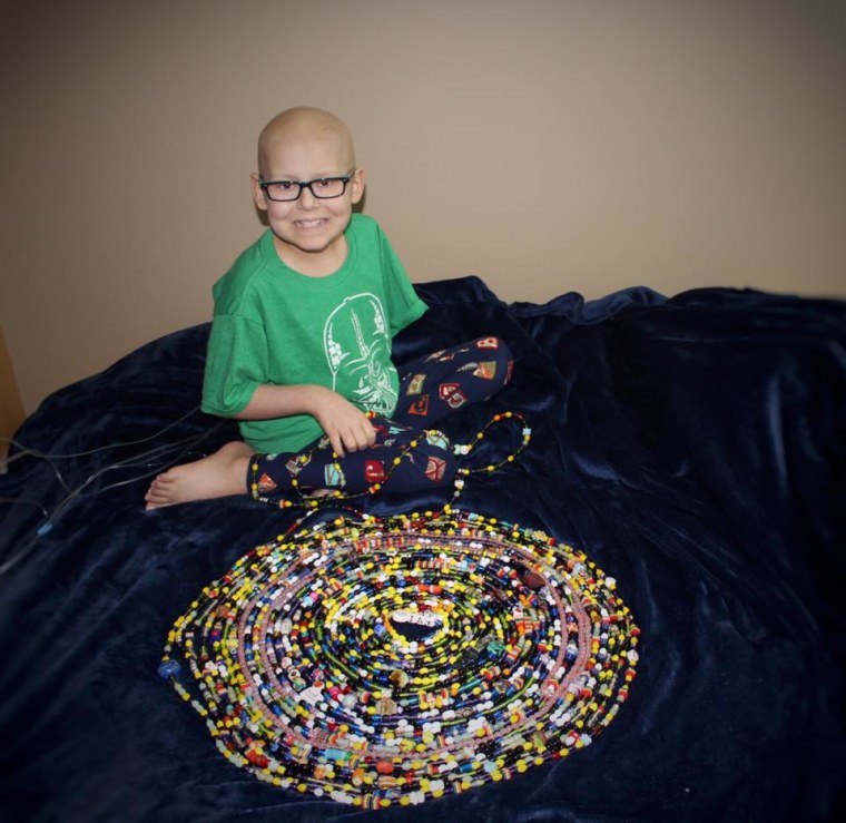 Jay with his "beads of courage," a collection of beads symbolizing aspects of his treatment such as chemotherapy sessions, blood transfusions and nights spent in the hospital