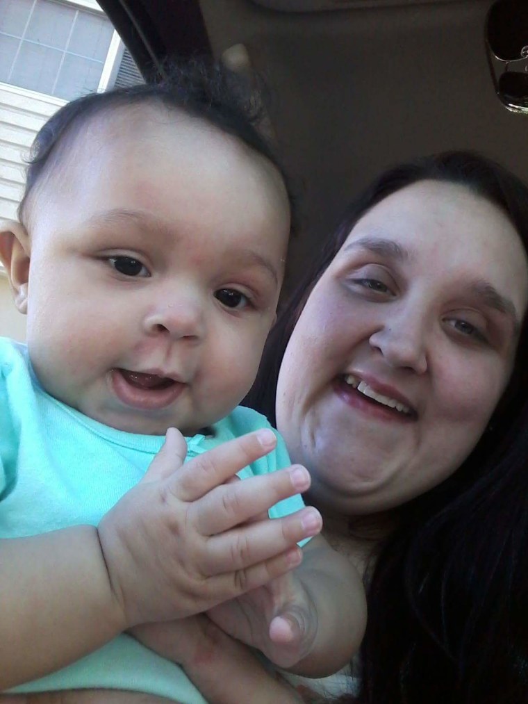 A photo of Hannah Simmons holding her infant daughter, A'lannah
