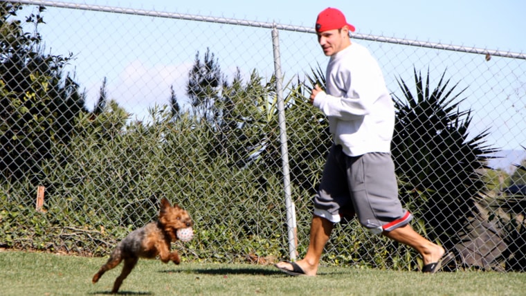 Nick Lachey plays outside with his dog, Wookie.