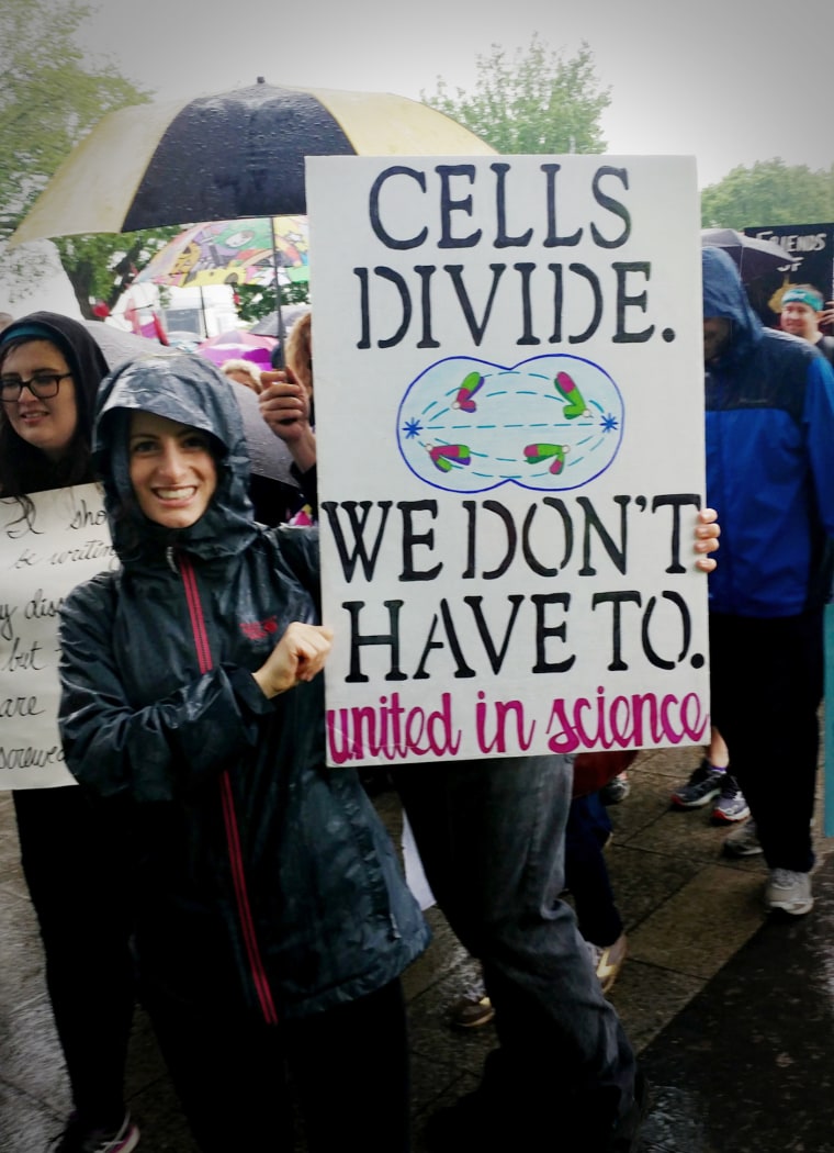 Image: Alison Wolf of Richmond, Virginia studies tobacco and nicotine at Virginia Commonwealth University. She said she wanted to stress that science is part of society's mainstream. She carried a sign saying, "Cells divide. Do we have to?"