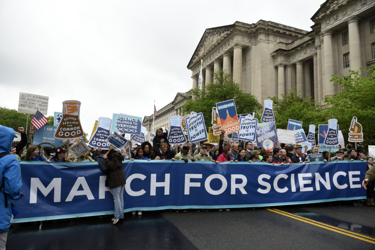 Image: People carry a March for Science banner and signs as they pass the U.S. Environmental Protection Agency during the March For Science in Washington, DC, April 22, 2017.