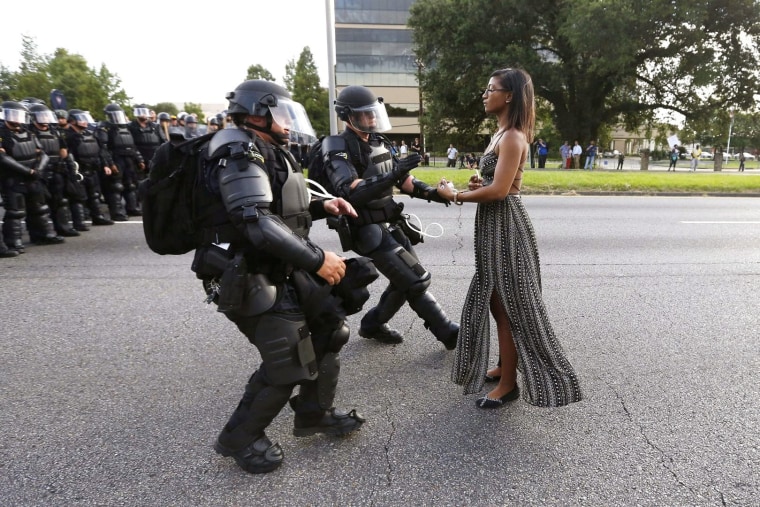 Image: FILE PHOTO --  Lone activist Ieshia Evans stands her ground while offering her hands for arrest as she is charged by riot police during a protest against police brutality outside the Baton Rouge Police Department in Louisiana