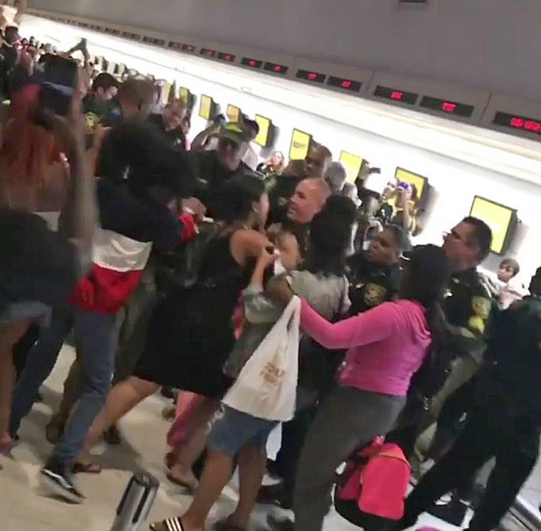 Police and passengers clash at Spirit Airlines counter at the airport in Fort Lauderdale.
