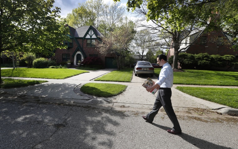 Image: Heath Mello walks through the Dundee neighborhood while canvassing for votes