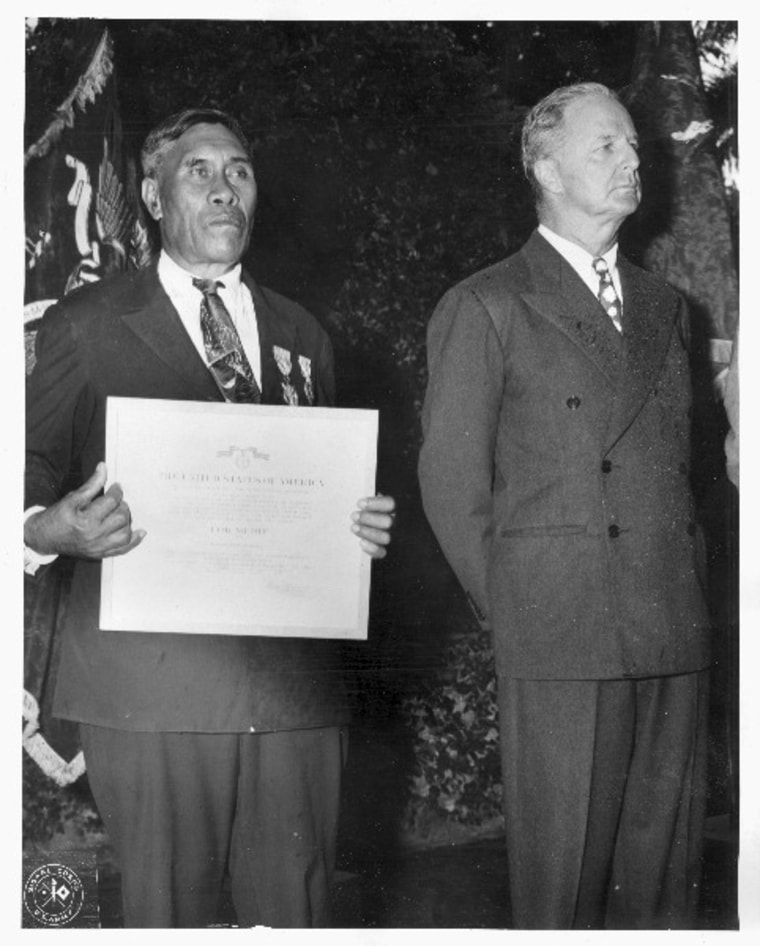 Benehaka "Ben" Kanahele (left), of Niihau, Hawaii, displays the Medal for Merit and Purple Heart awarded to him for killing a Japanese Pilot who landed on Niihau after the Dec. 7, 1941, attack on Pearl Harbor. The pilot shot Mr. Kanahele three times before being killed by the Hawaiian.