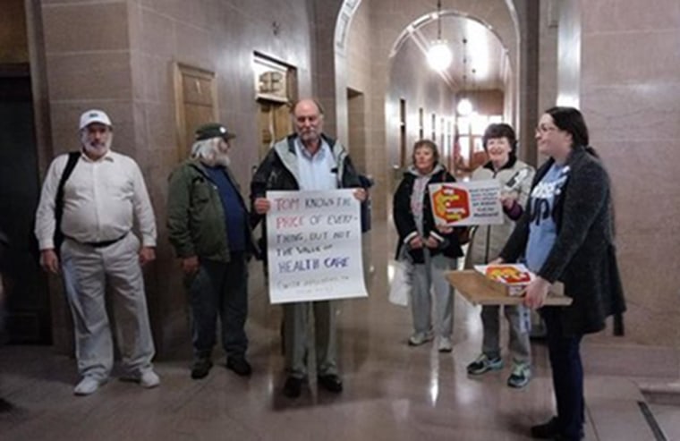 Image: Reporter Dan Heyman waits at the State Capitol to cover Tom Price