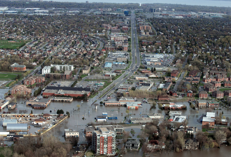 Image: An overhead view showing St Jean Blvd., in the flooded residential neighbourhood in Pierrefonds, Quebec, Canada