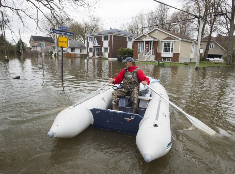 Image: A resident makes his way through flooded streets