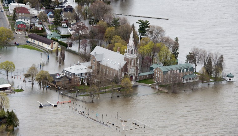 Image: An aerial photo shows a church surrounded by floodwaters in Oka