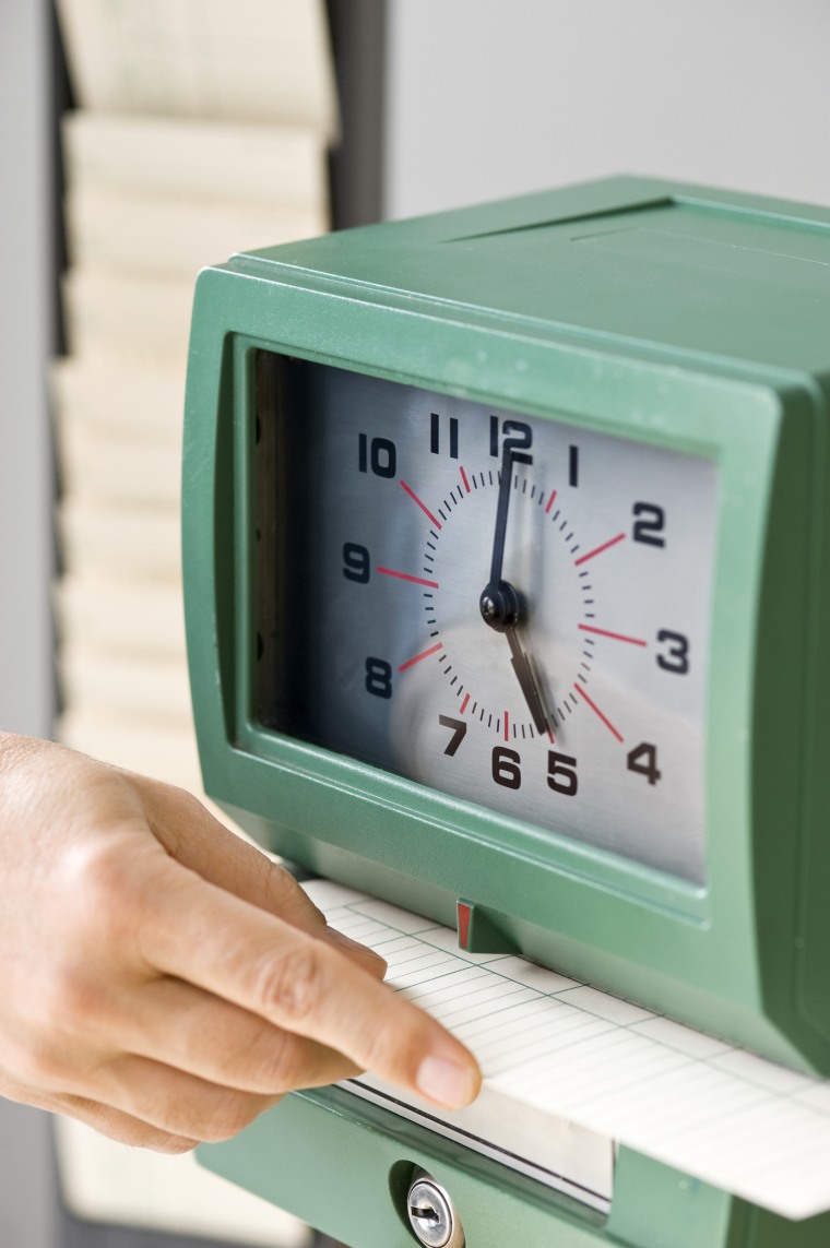 Image: Man Punching Card in Time Clock