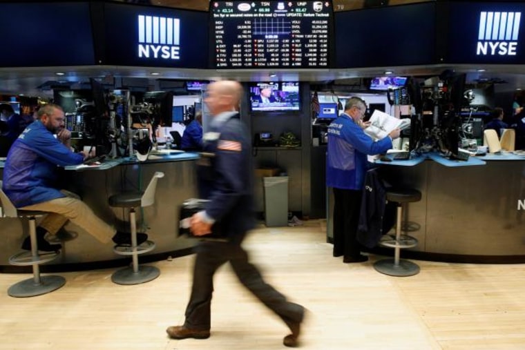 Traders work on the floor of the NYSE