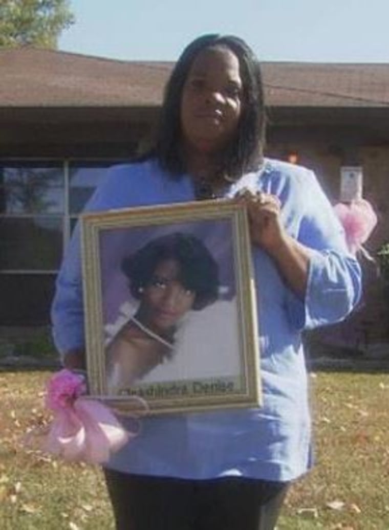 Laurell Hall holds a photo of her missing daughter, Cleashindra.